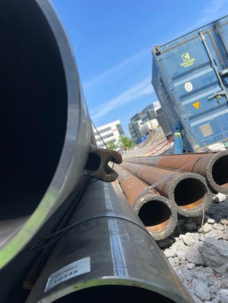 A tilted view of metal pipes on a construction site